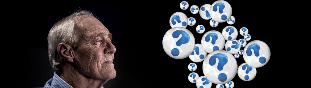 man looking at bubbles with question marks in them