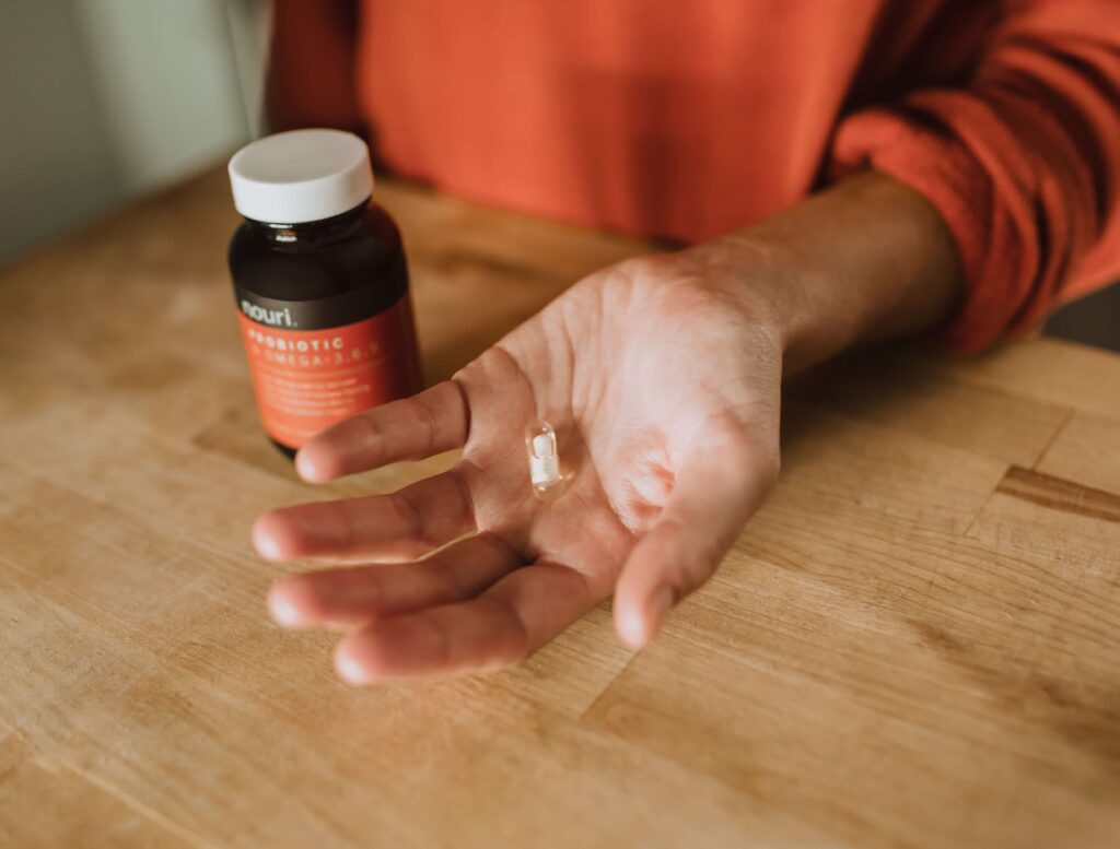 closeup of hand holding pill