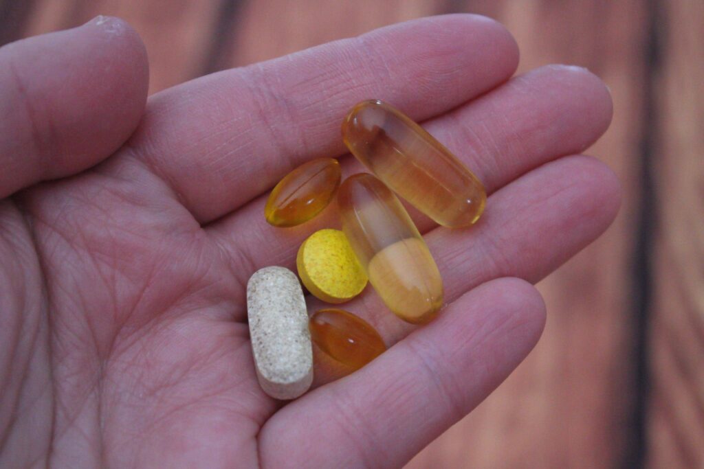 hand holding various medications