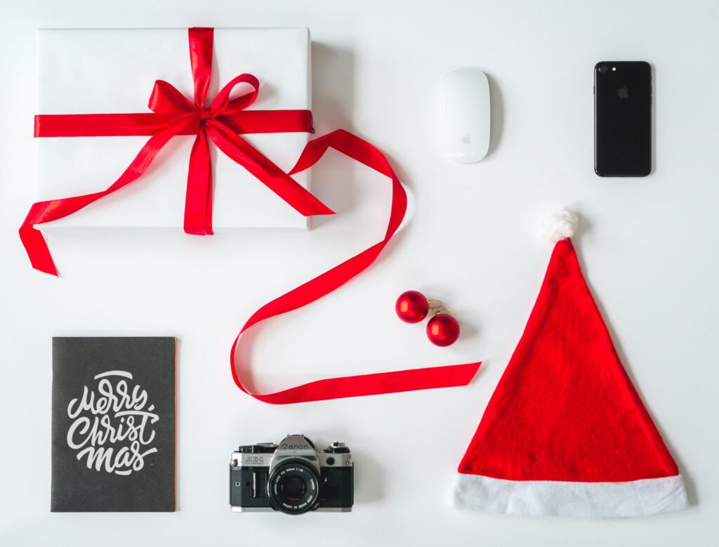 wrapped gift, phone, computer mouse, Christmas card, camera, Santa hat, and two ornaments