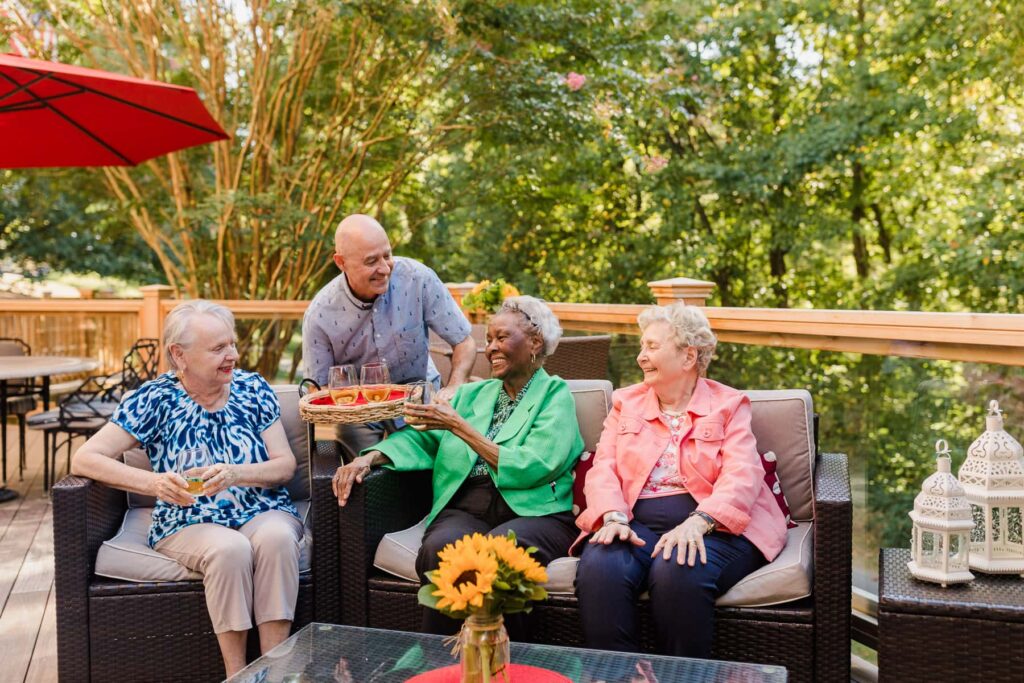 residents taking wine off of platter from server