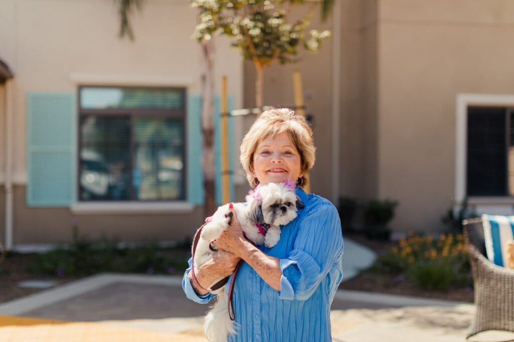 woman holding small dog