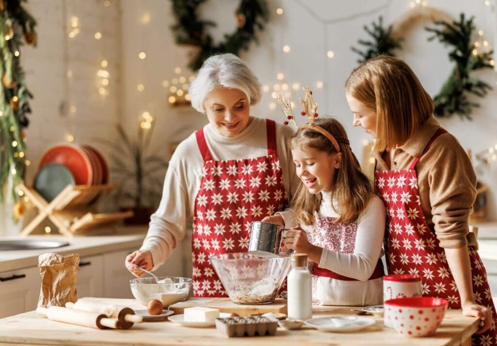 daughter, mother, and grandmother baking Christmas cookies