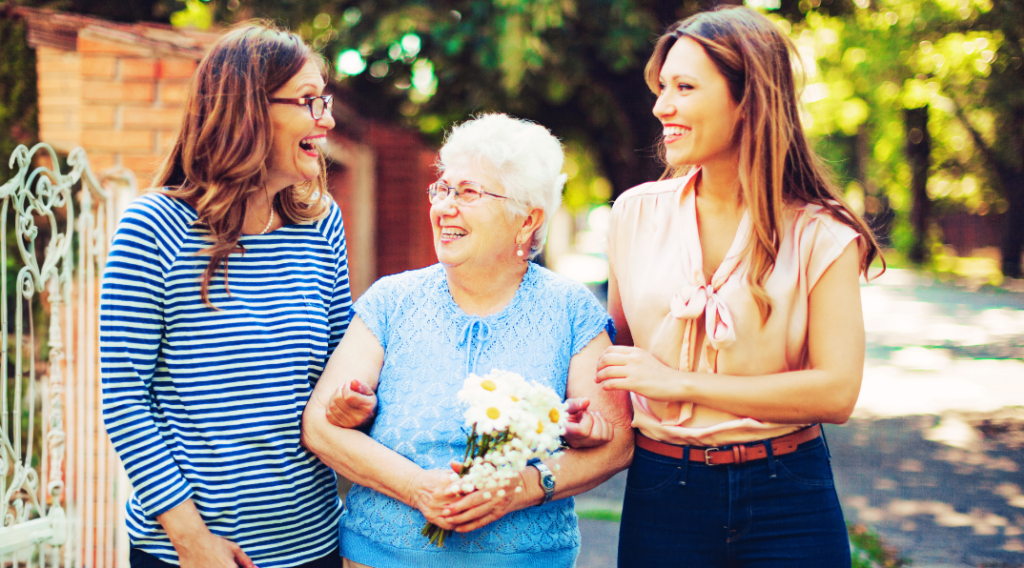two women walking with elderly lady