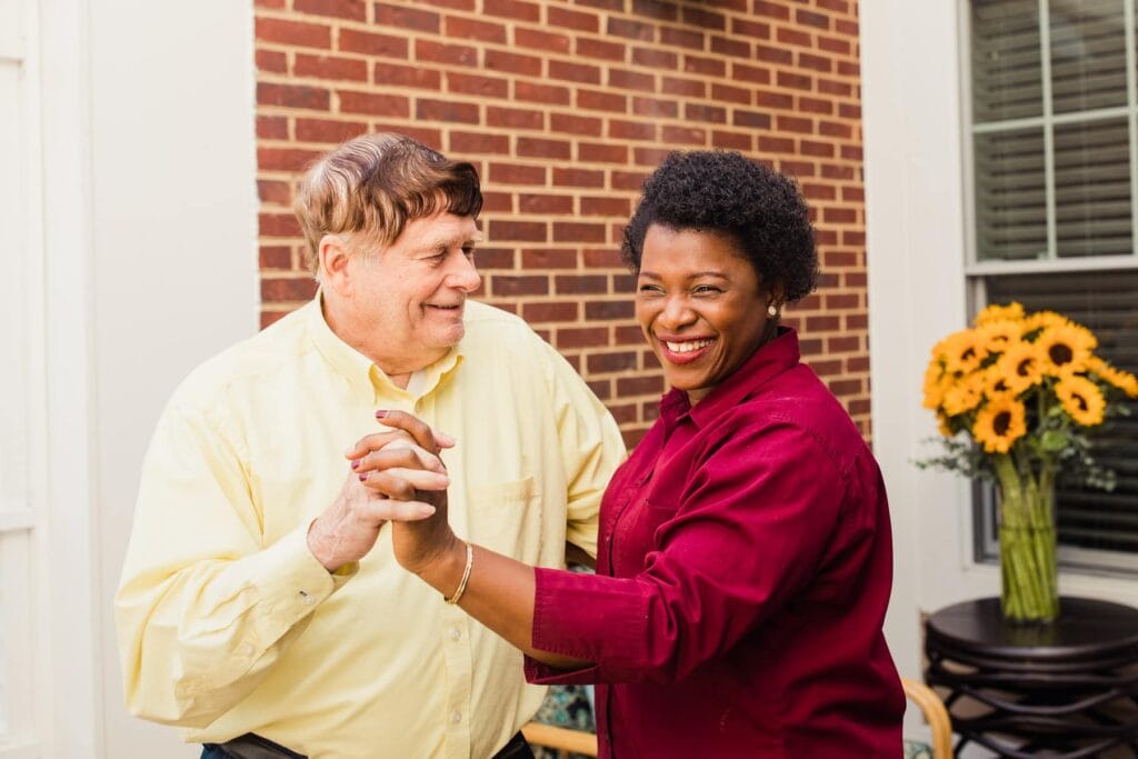 resident and caregiver dancing