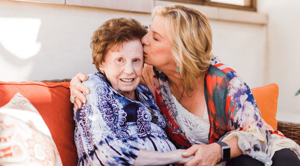 Women and elder mother embrace