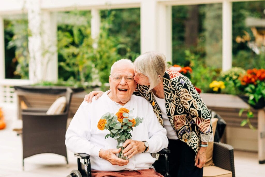 family member kissing resident's cheek