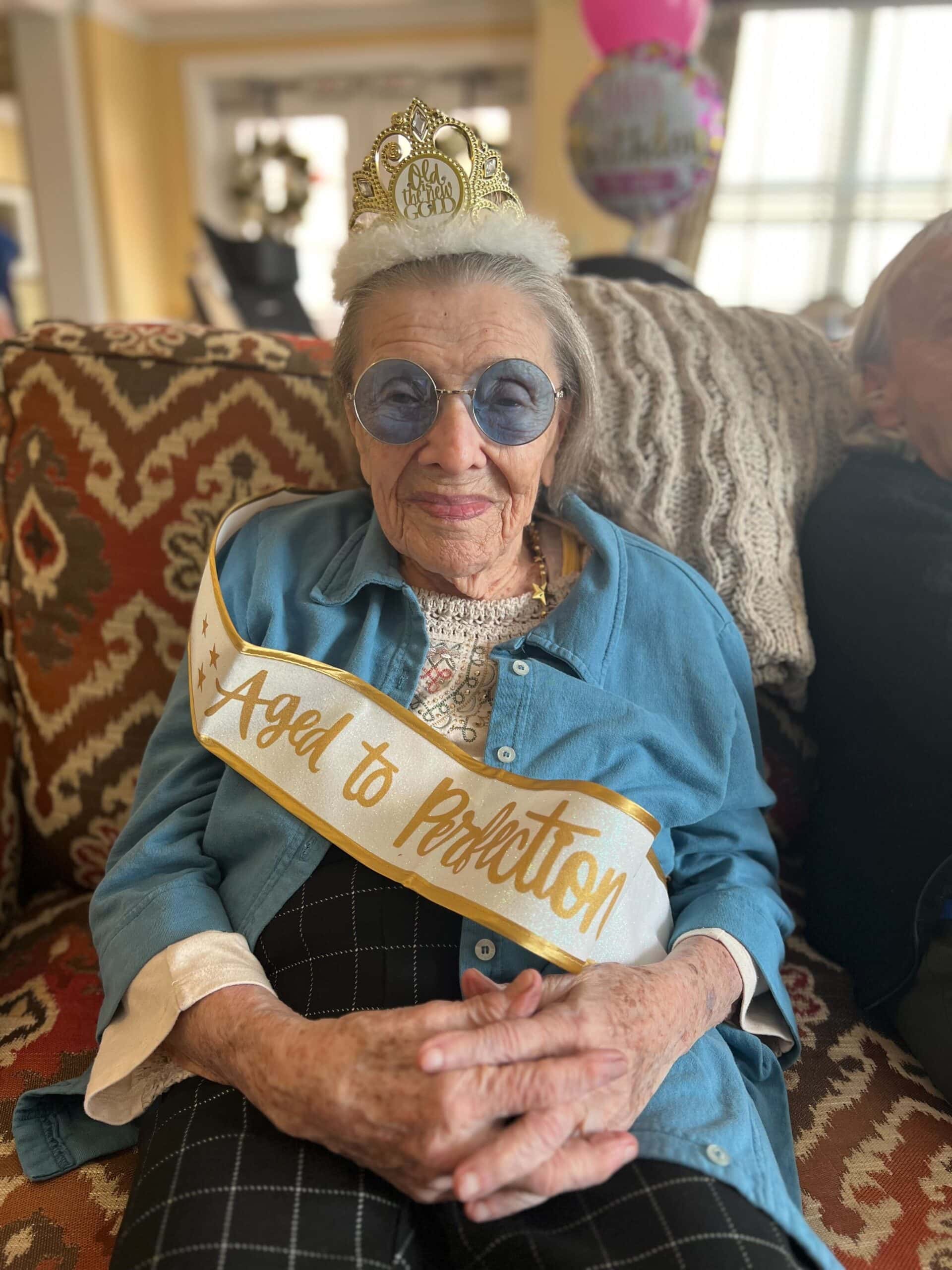 resident in birthday crown and sash