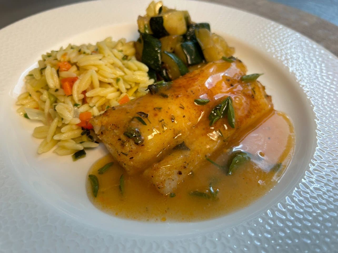fish entree with orzo and vegetables