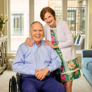 older gentleman on a wheelchair and his wife