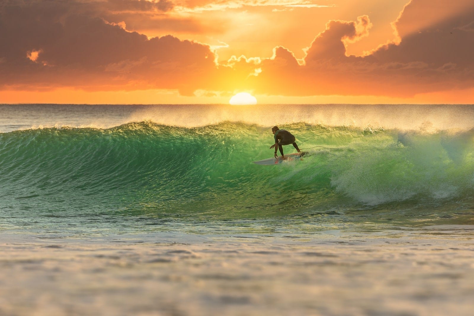 surfer surfing during sunrise