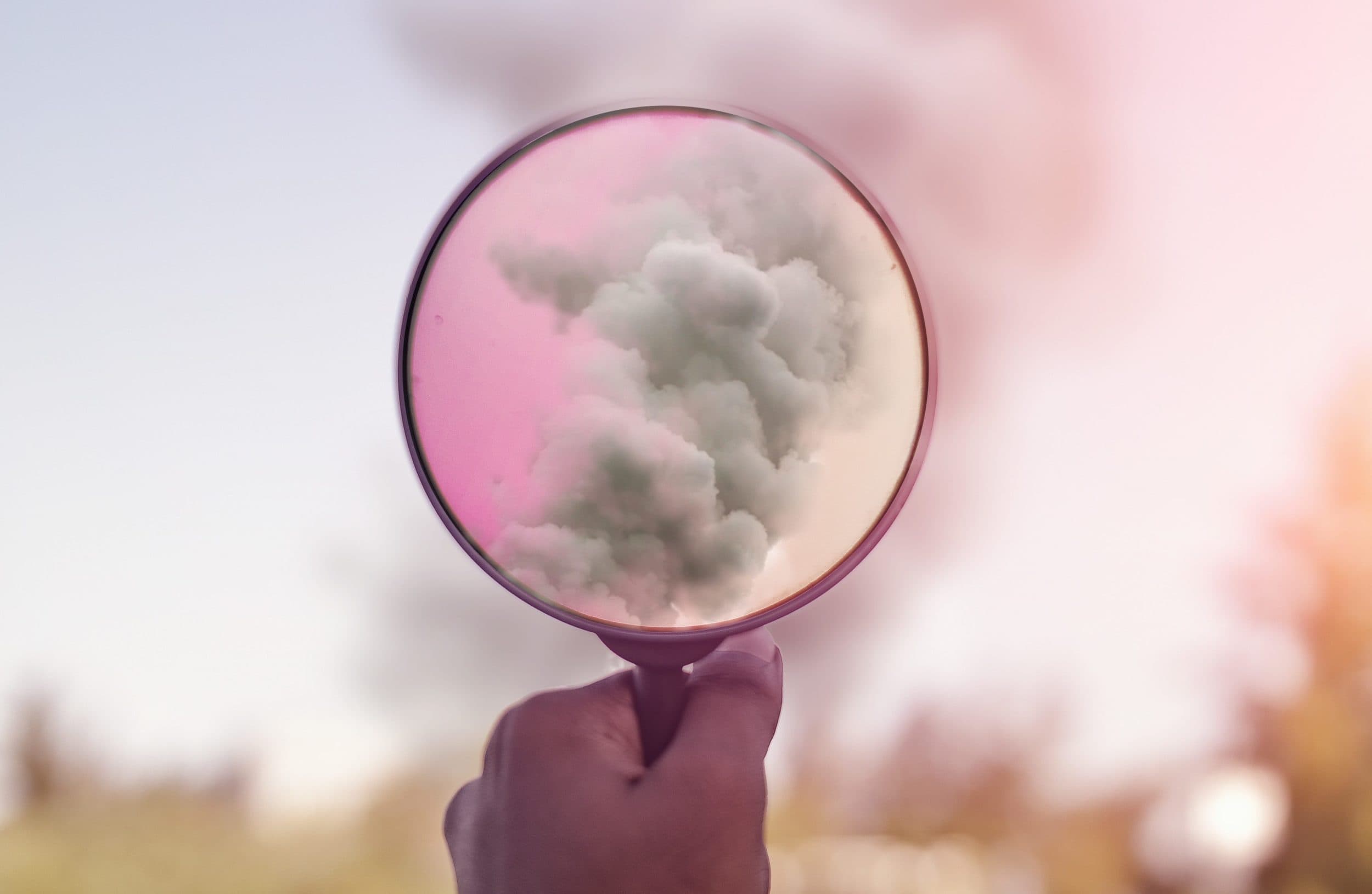 magnifying glass in front of a cloud
