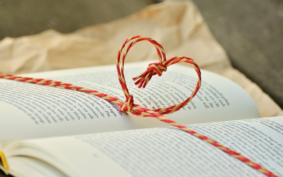 A book with a heart made of twine.