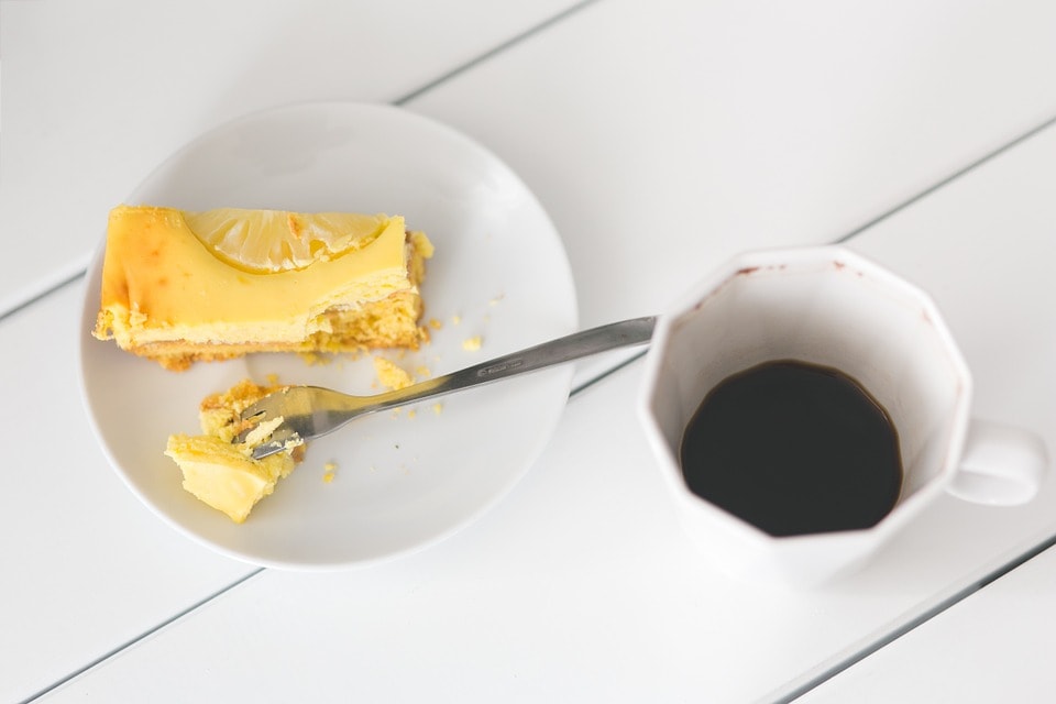 lemon bar cheesecake with cup of coffee