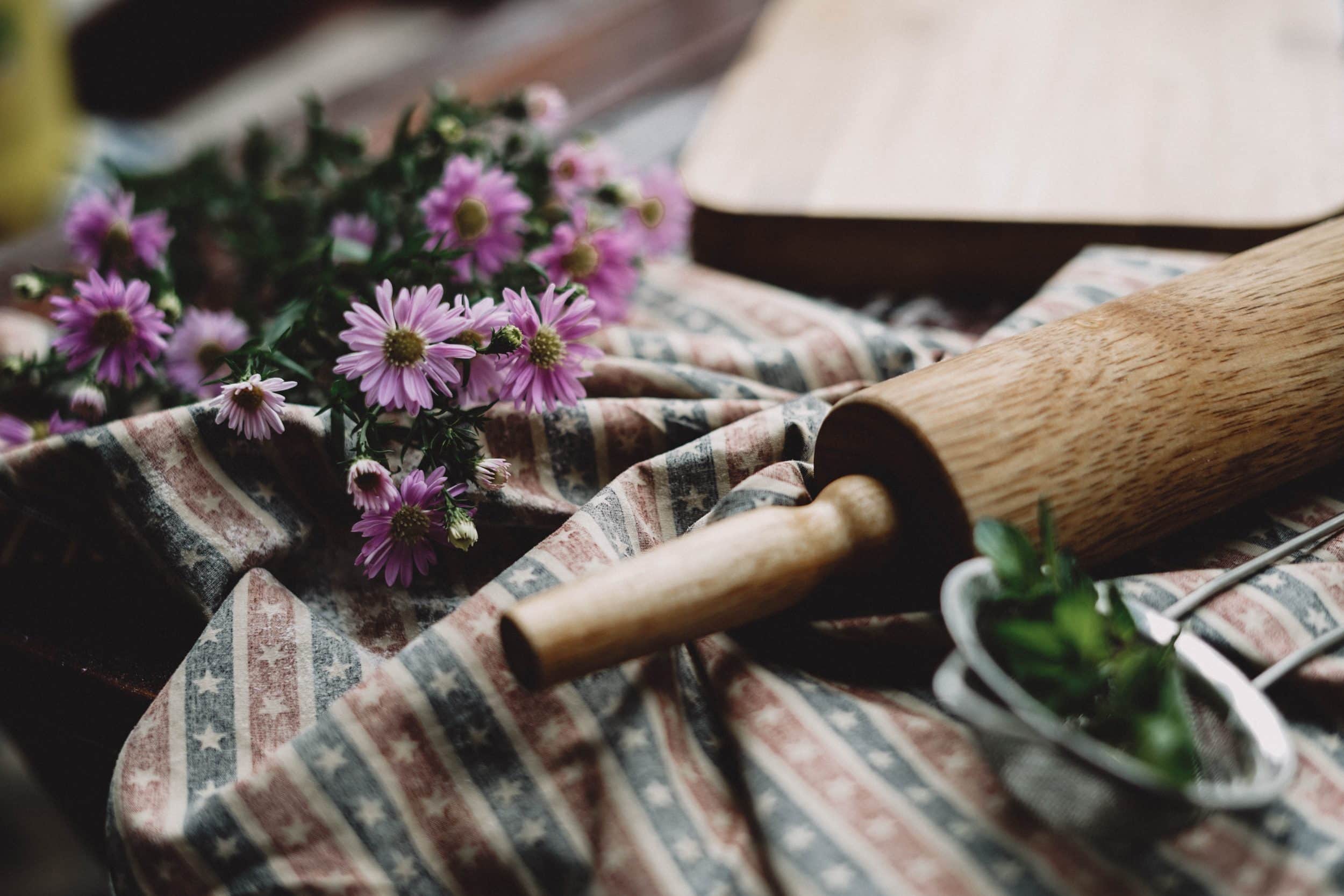 Flowers and rolling pin on striped table cloth