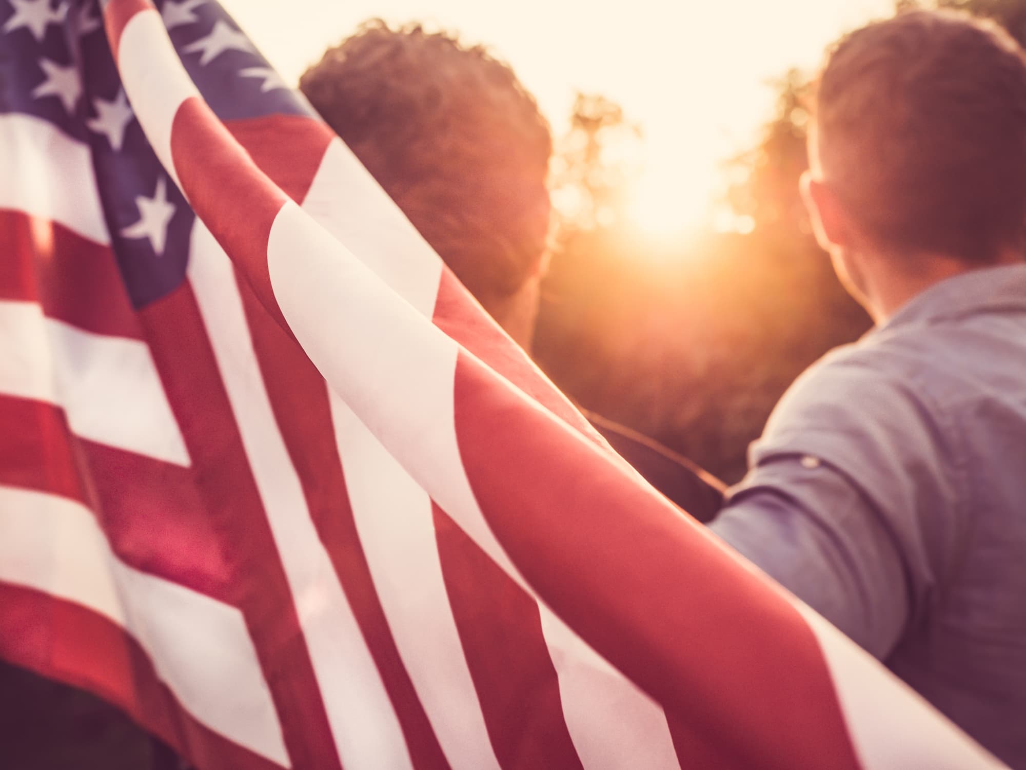 stock photo of people holding an american flag