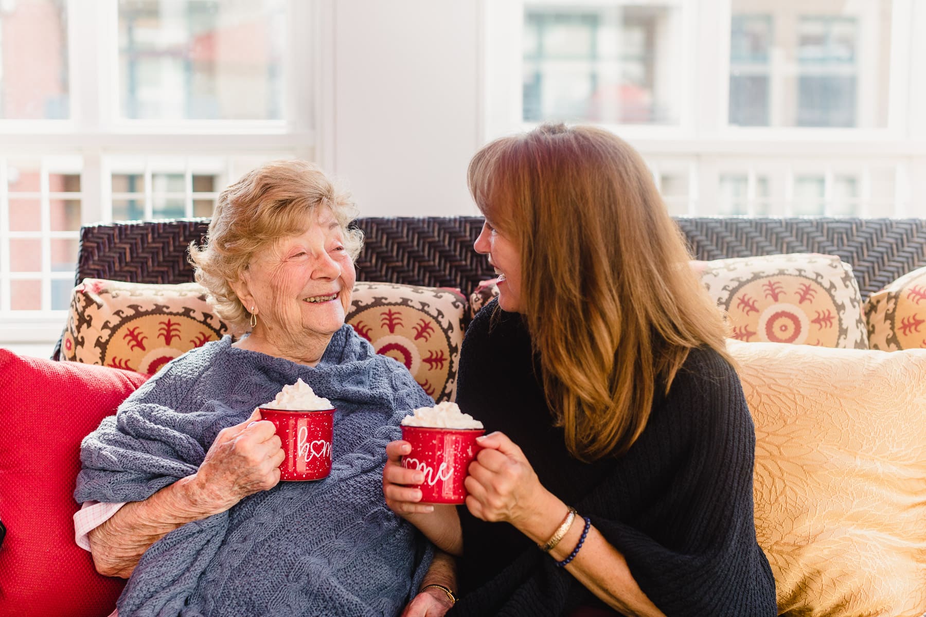 elderly woman and caregiver enjoying coffee