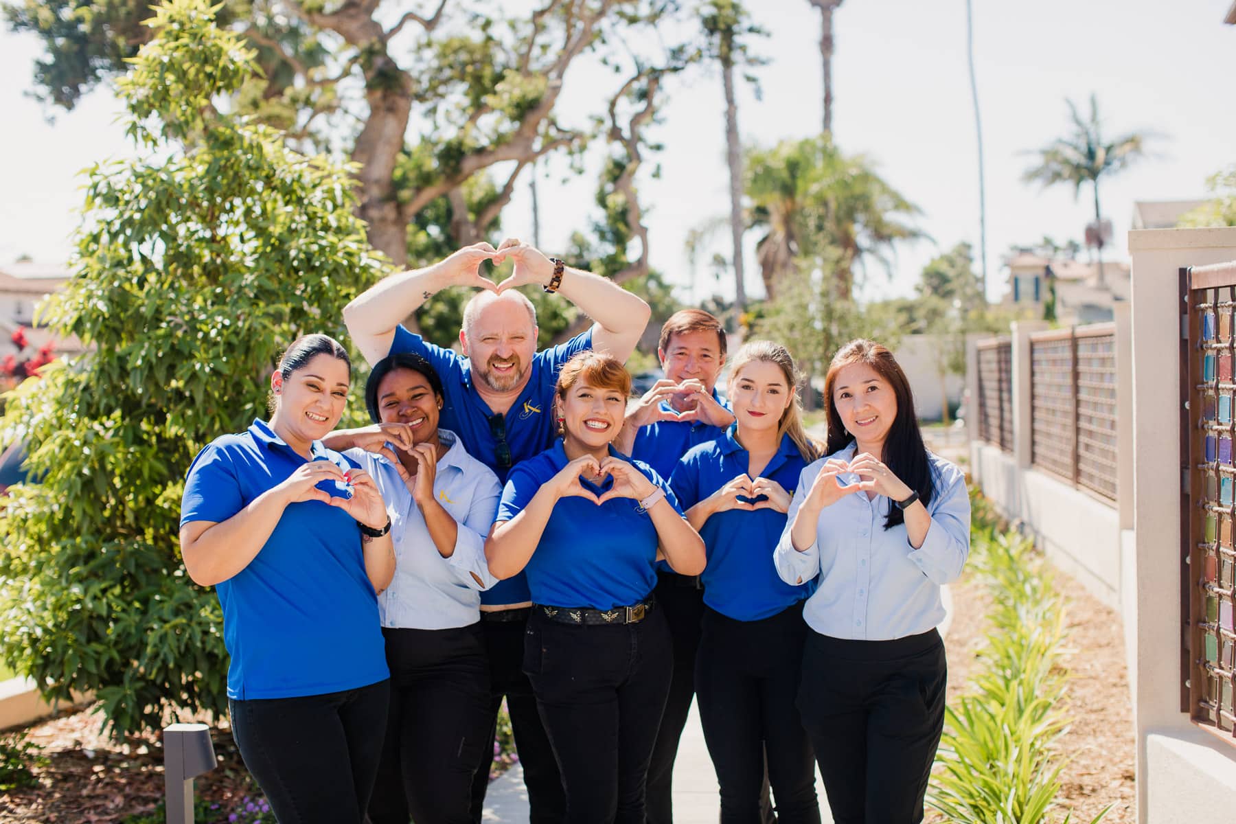 employees making a heart sign