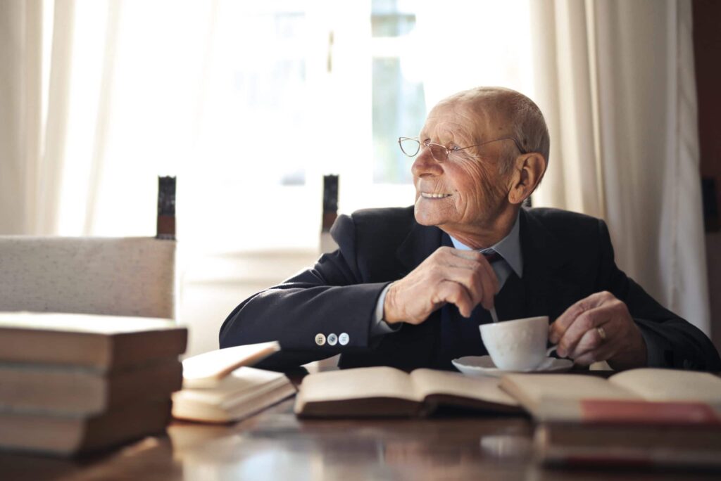 elderly man with coffee smiling