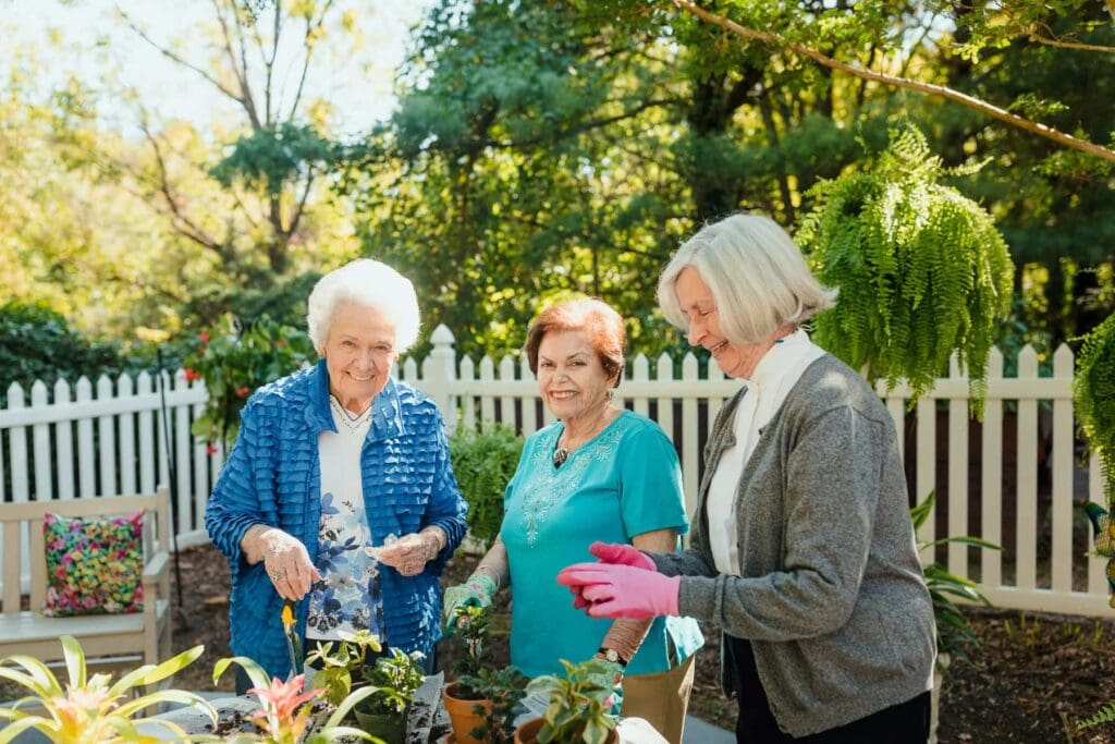 three residents gardening together