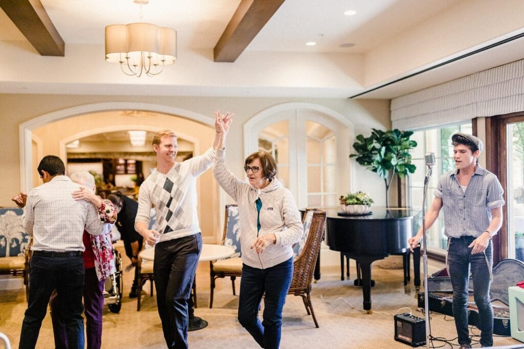 residents and caregivers dancing