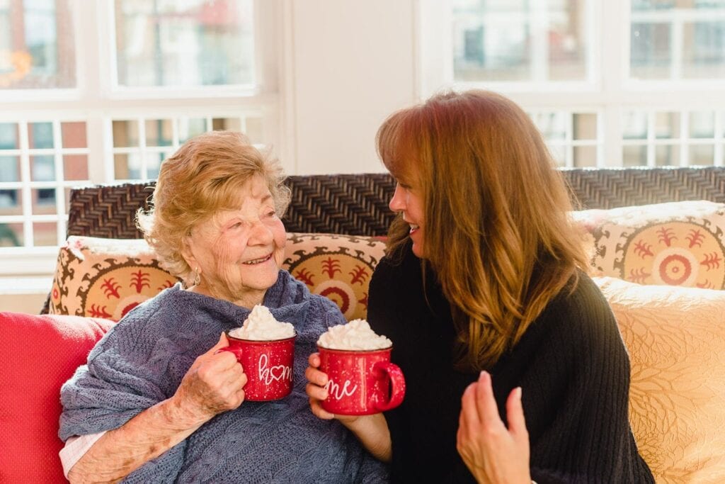 elderly resident and woman with mugs