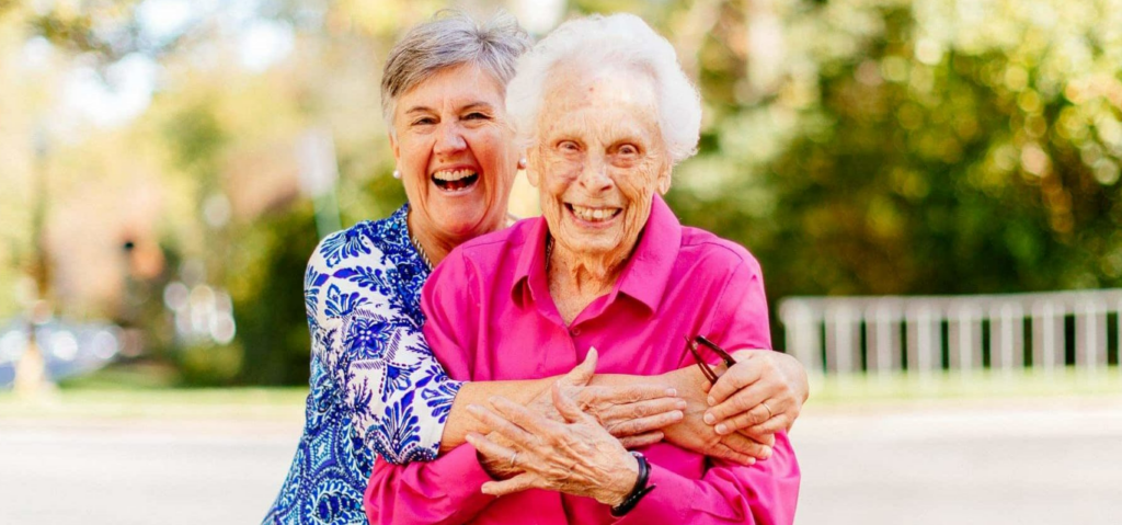 caregiver hugging elderly woman