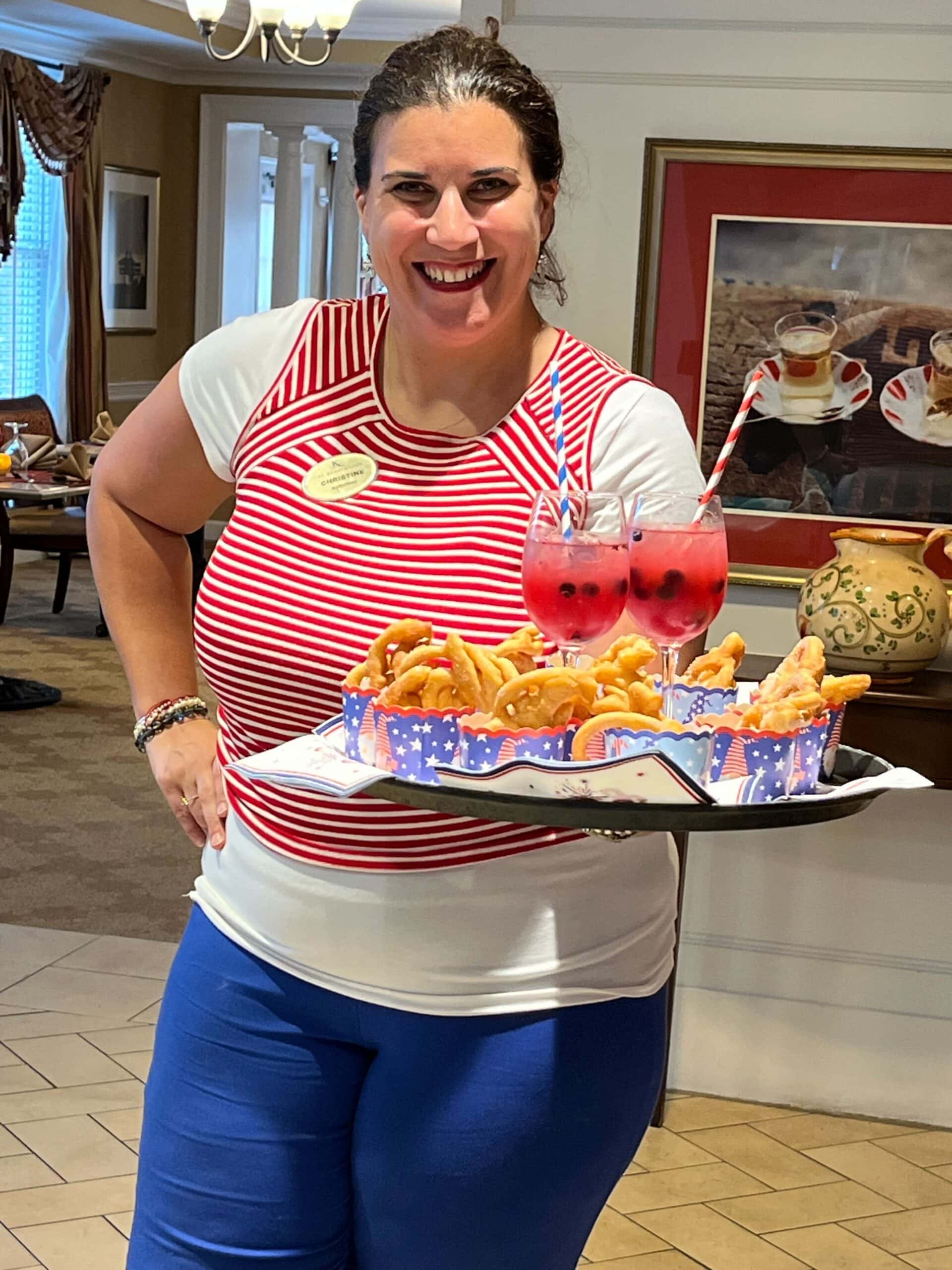 team member holding tray with snacks and beverages