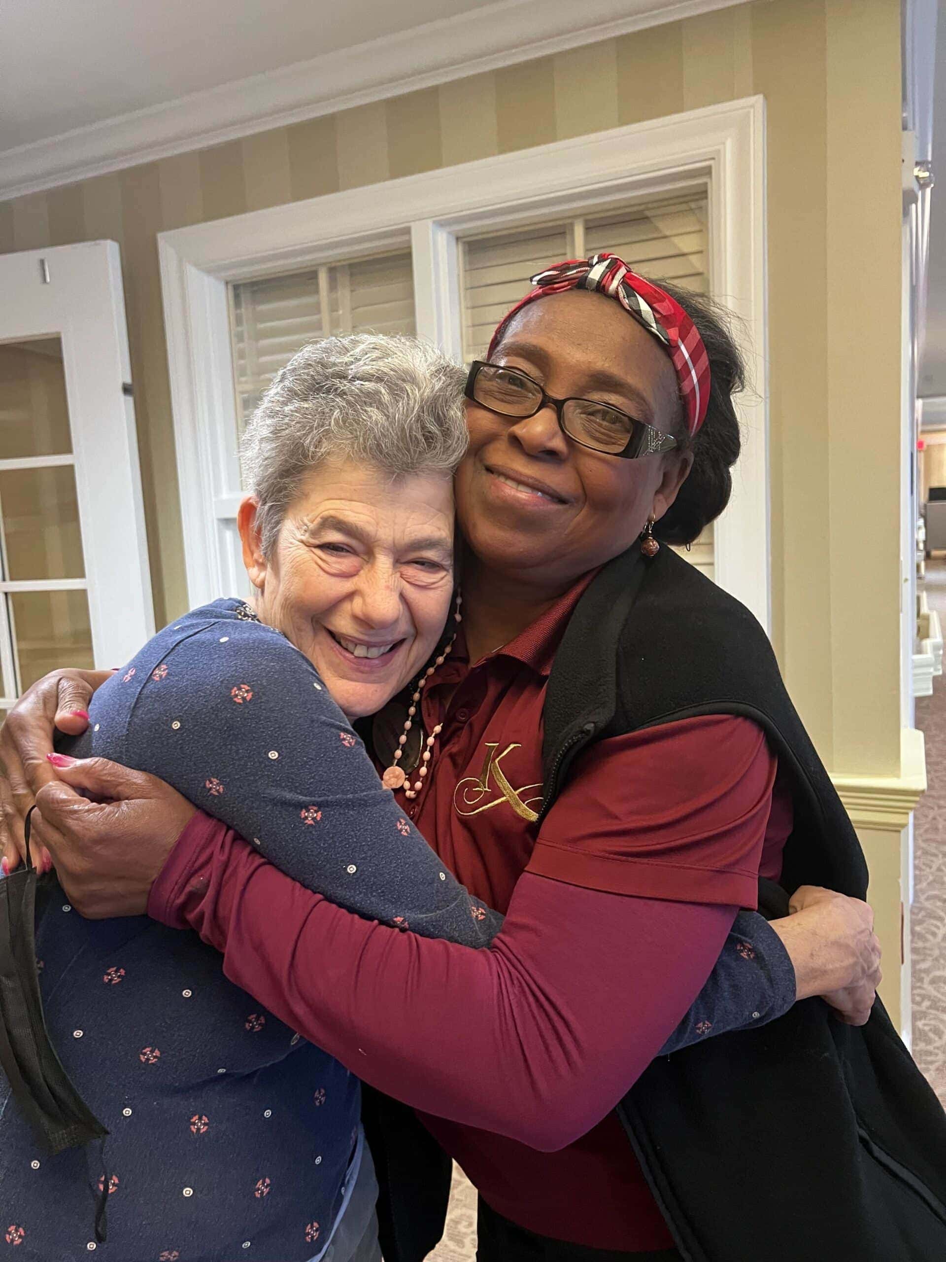 care team member and resident hugging