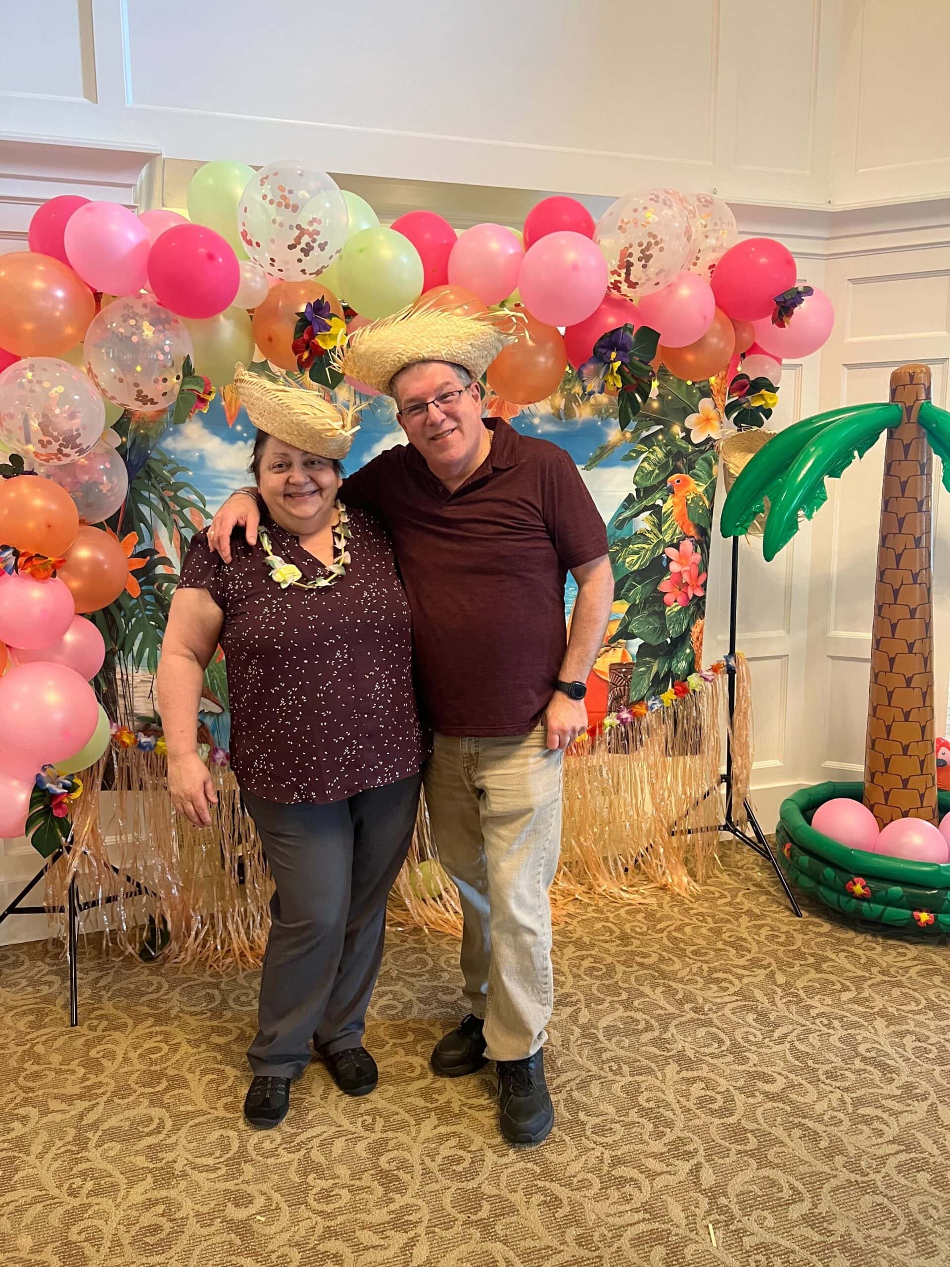 two care team members dressed up for luau party