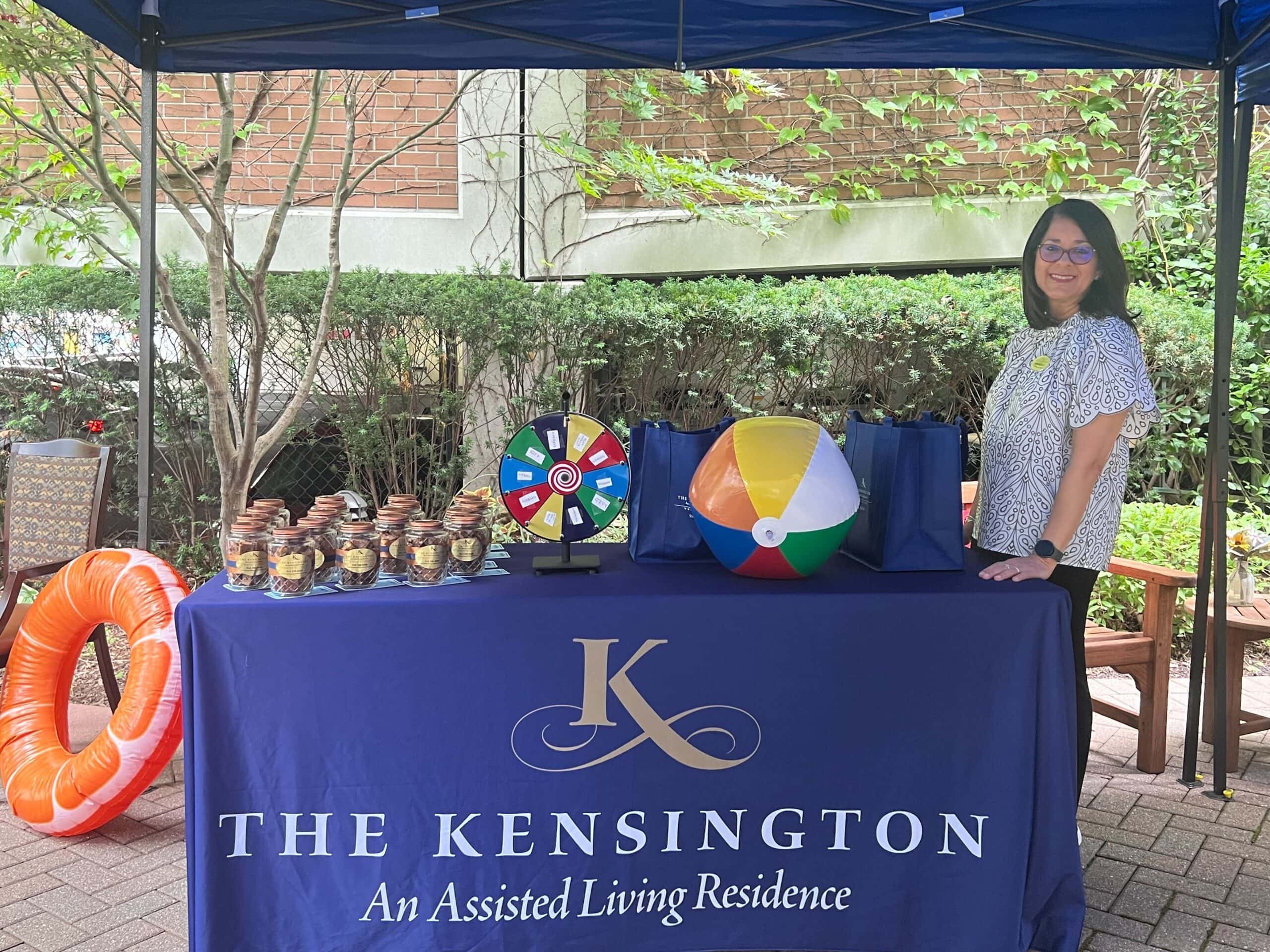 team member with table set up at community event