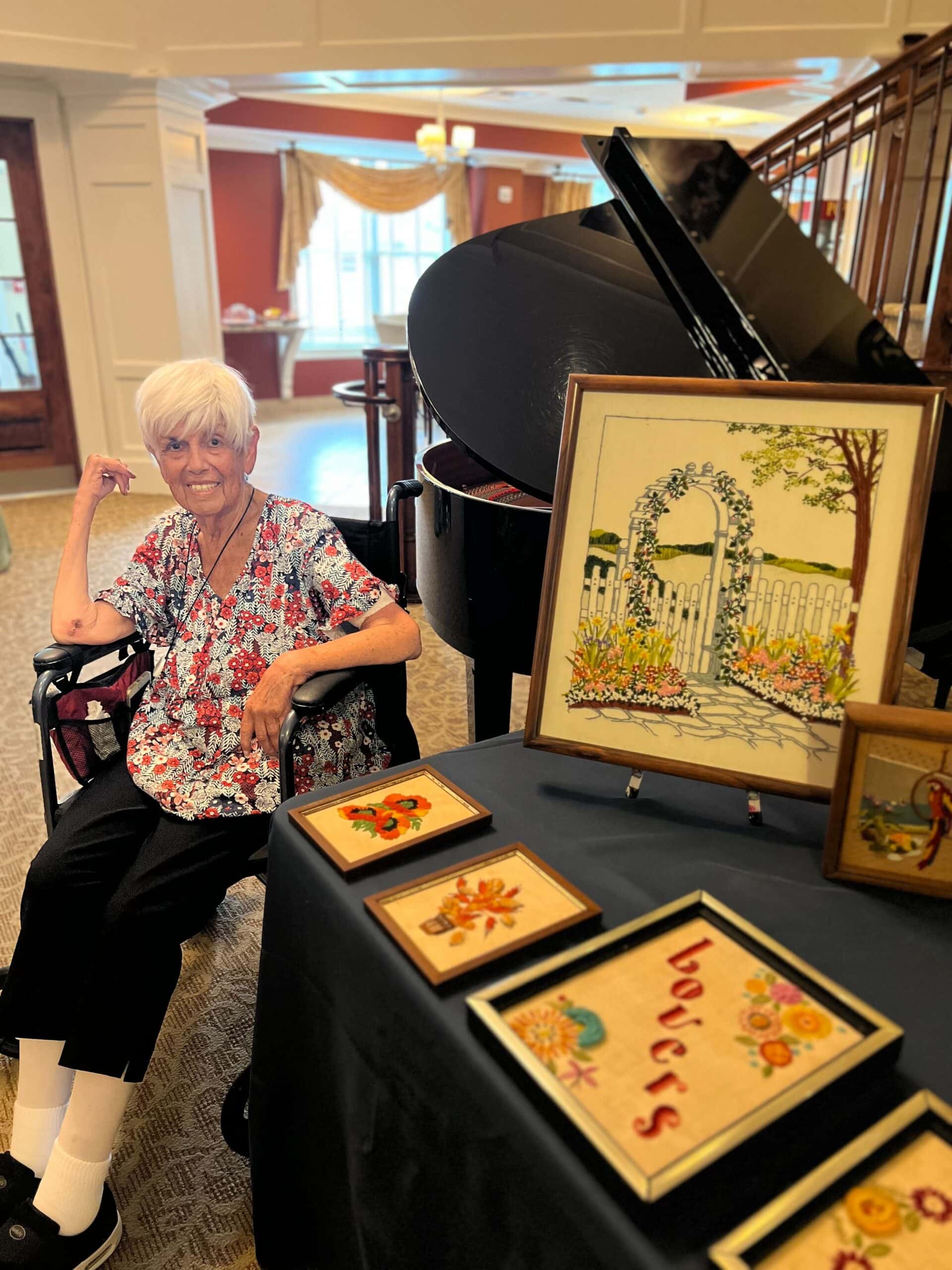 resident by piano with artwork displayed