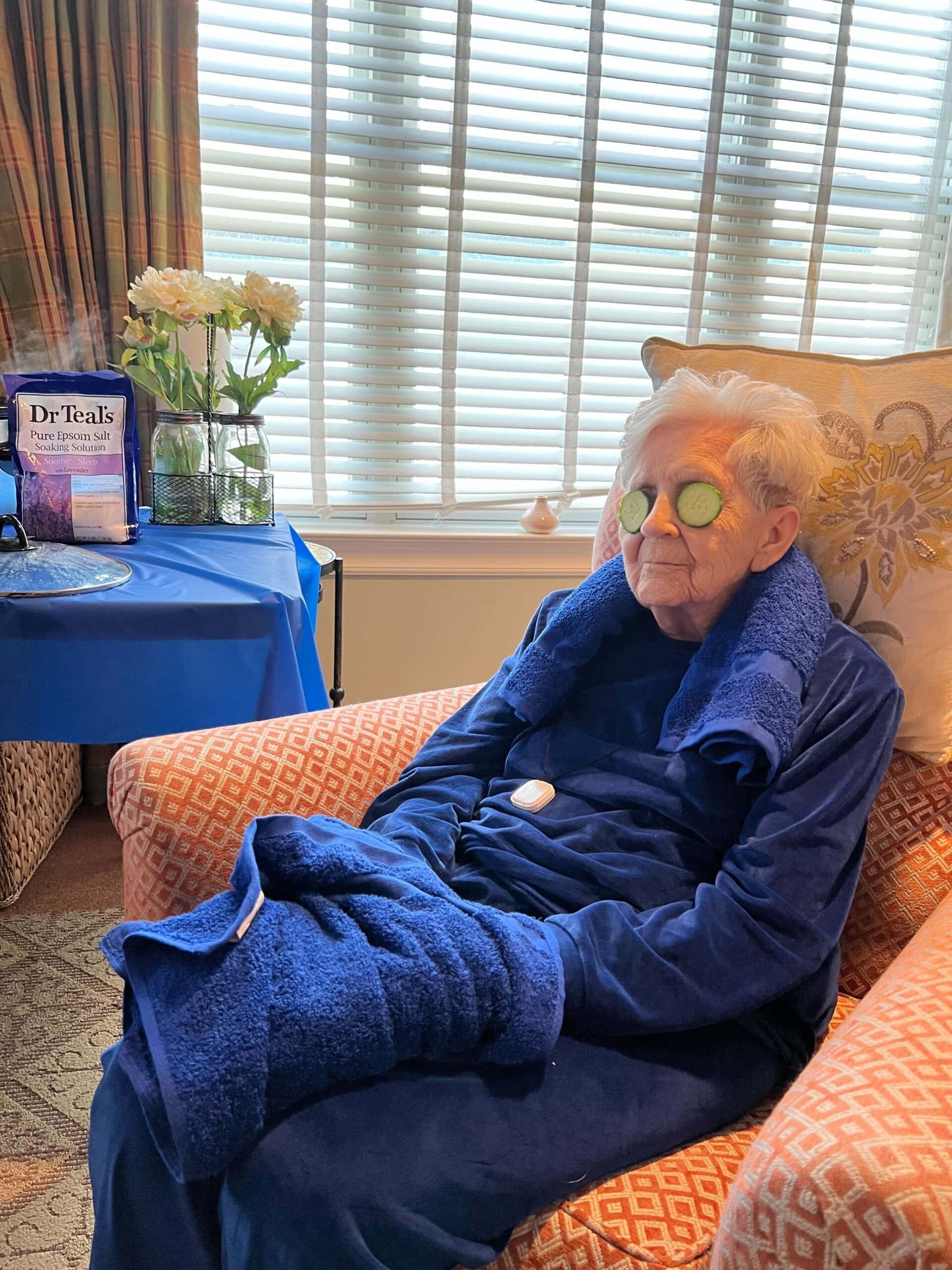 resident getting spa treatment with cucumbers on eyes