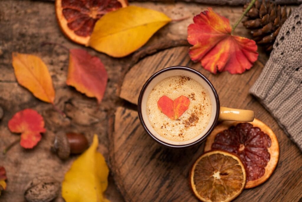 mug full of coffee with fall leaves