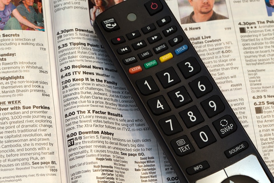 Television Remote Control on TV Guide Paper